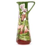 A Moorcroft pottery jug in the Himalayan Orchid pattern designed by Philip Gibson, with tube lined