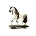 A pull along hobby horse, 59cm wide, 69cm high