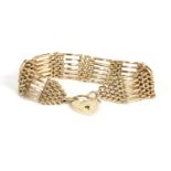 A gold six row gate link bracelet, with padlock, marked 9ct gold, 23.56g