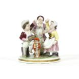 A Frankenthal porcelain figure, depicting three figures and a monkey, marked to base