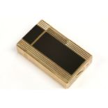 An S T Dupont gold plated lighter, set with Japanese black lacquer inlay, with printed oriental