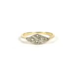 An Art Deco gold four stone diamond lozenge shaped ring, tested as approximately 18ct gold, 2.15g