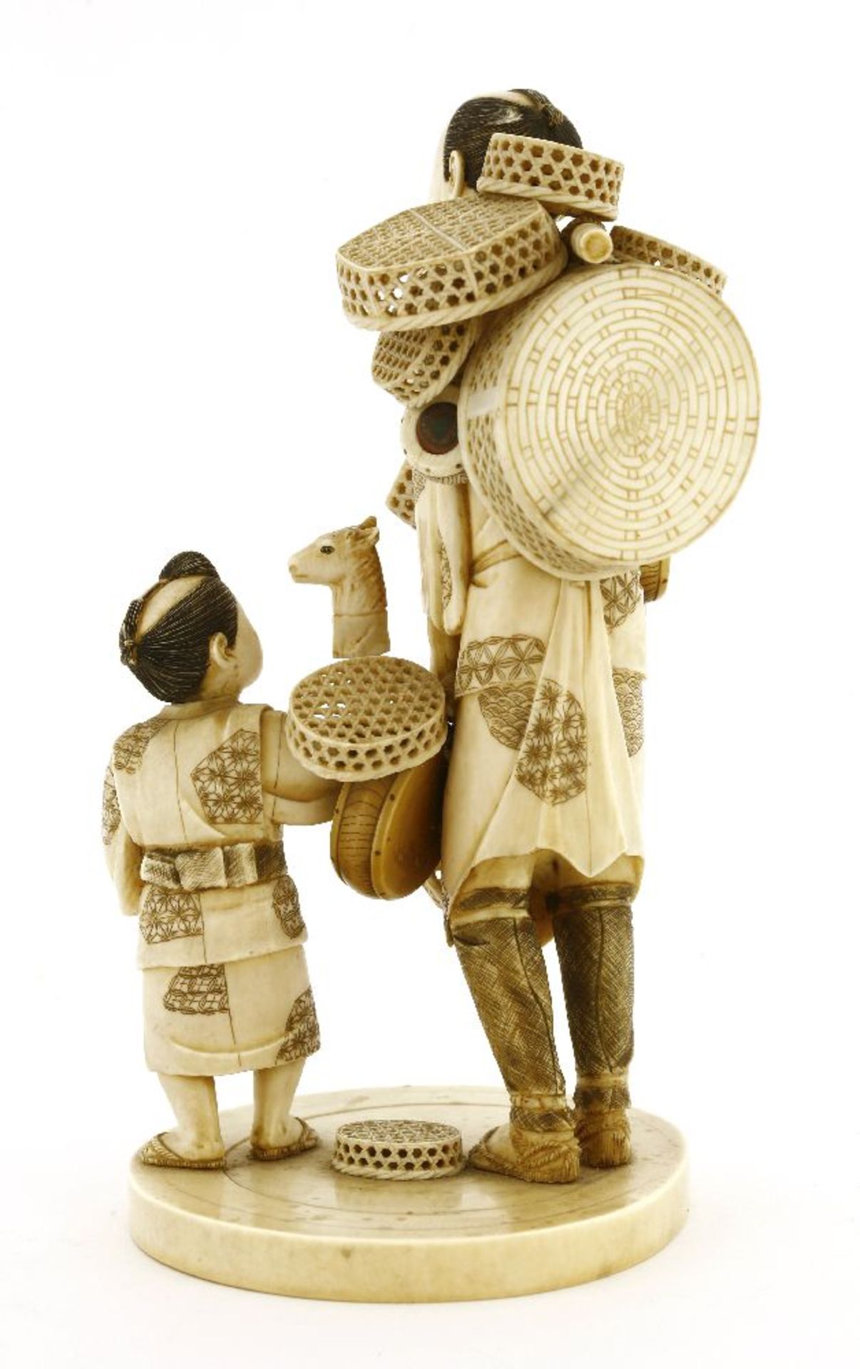 A Japanese ivory okimono,c.1920, of a basket seller, with a bamboo yoke hung on his shoulder with - Image 2 of 3