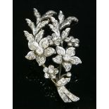 A late Victorian diamond set spray brooch, c.1890,with a graduated flower head. The principal flower