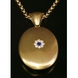 A Victorian, oval, gold, hinged locket, with a sapphire and diamond cluster to the front cover,a