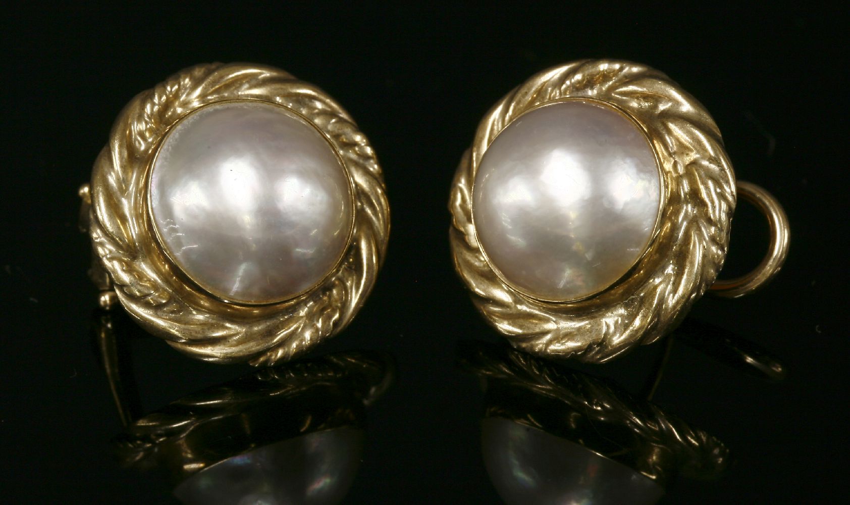 A pair of 9ct gold cultured mabé pearl earrings,with a 12mm mabé pearl, rub set to the centre. A