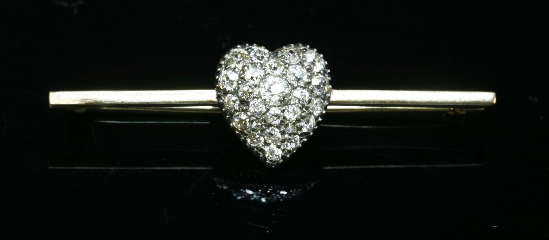 A diamond set heart-shaped bar brooch,with a Victorian diamond set heart, grain set with graduated