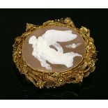 A cased late Georgian gold mounted shell cameo, c.1825, an oval landscape carved shell cameo