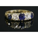 A late Victorian sapphire and diamond carved head ring, with three oval mixed cut sapphires and