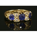 An 18ct gold Victorian sapphire and diamond carved head ring,with three circular old Swiss cut