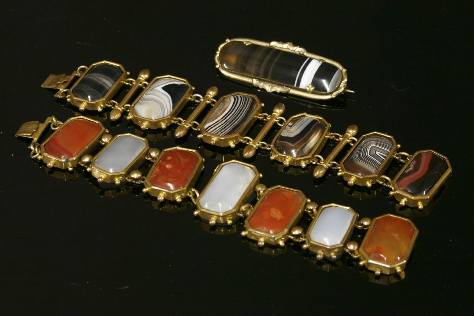 A gilt metal agate panel bracelet, c.1830, with a series of rectangular cut corner agate tablets,