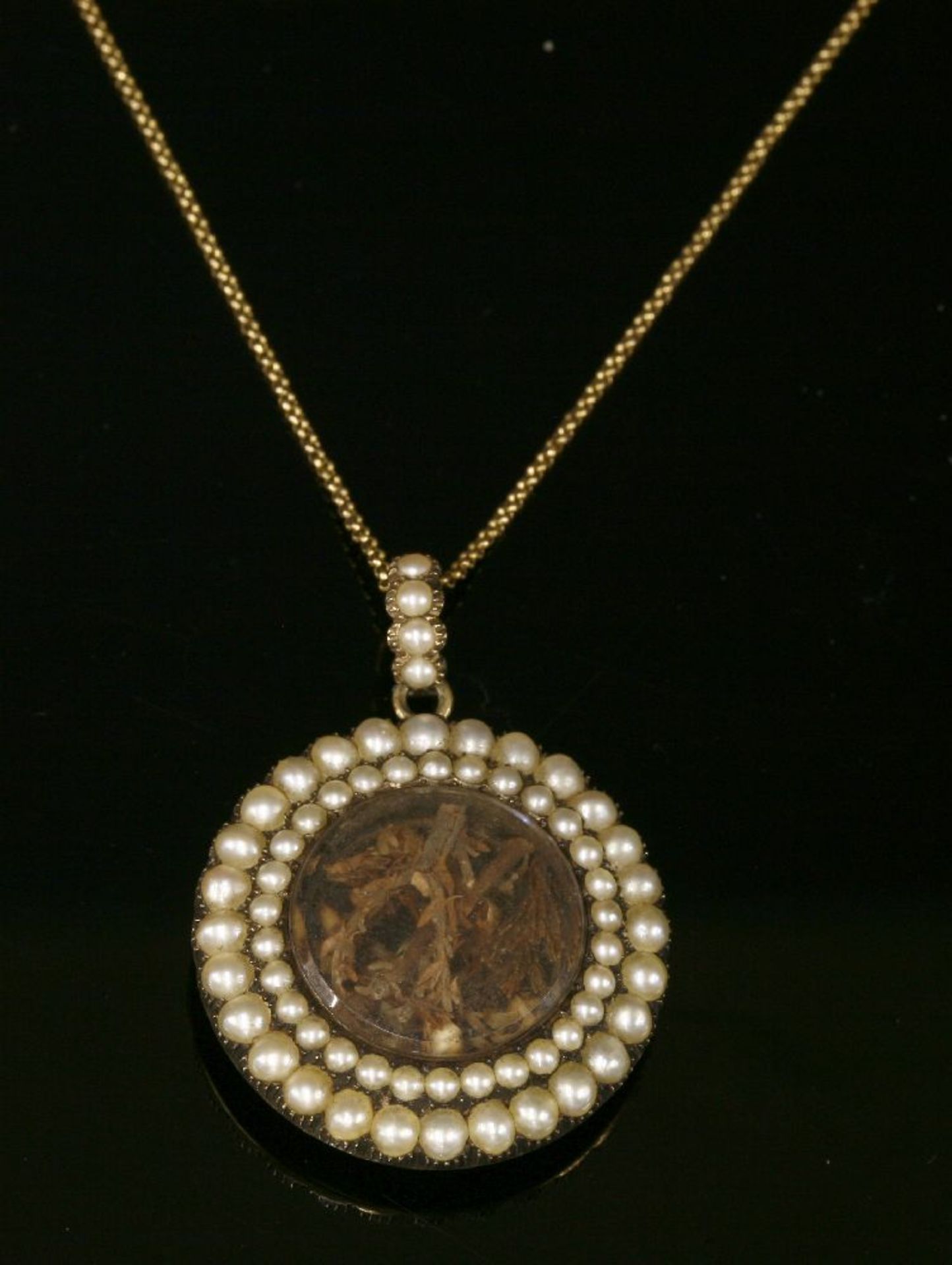 A Georgian split pearl circular glazed pendant,with two rows of graduated split pearls, all in cut