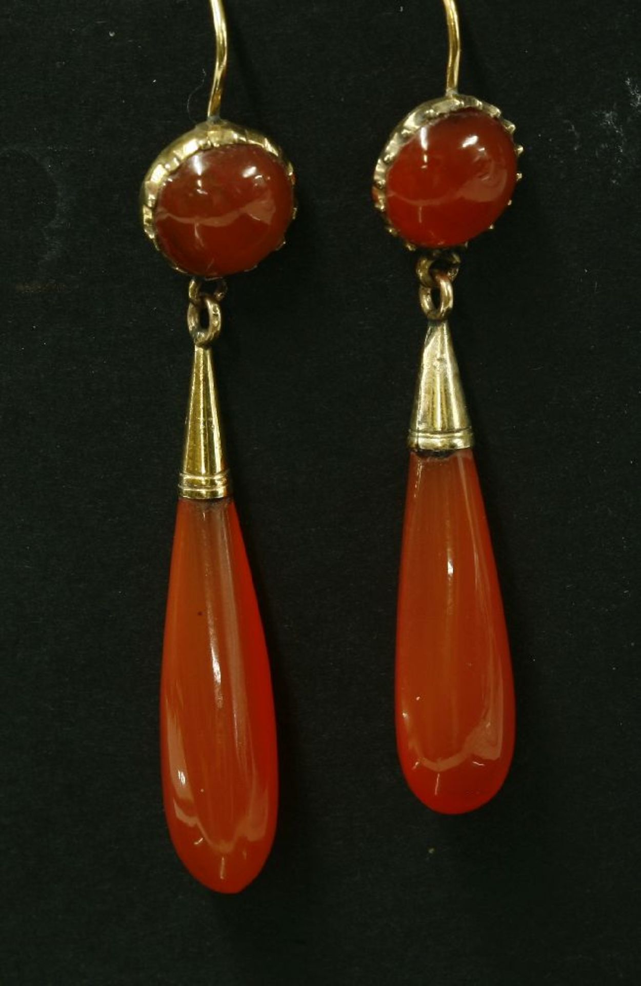 A pair of Victorian gold cornelian drop earrings,with a circular cabochon concealed in a cut down