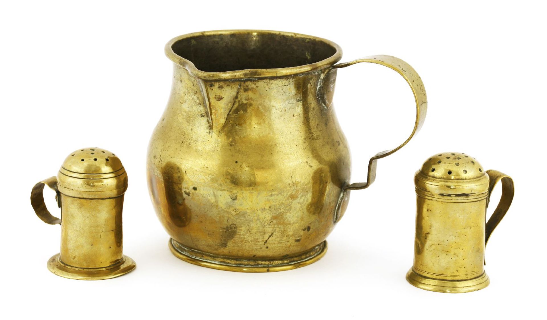 A George III brass ale measure,of squat form with a shaped handle to one side,12cm high,together