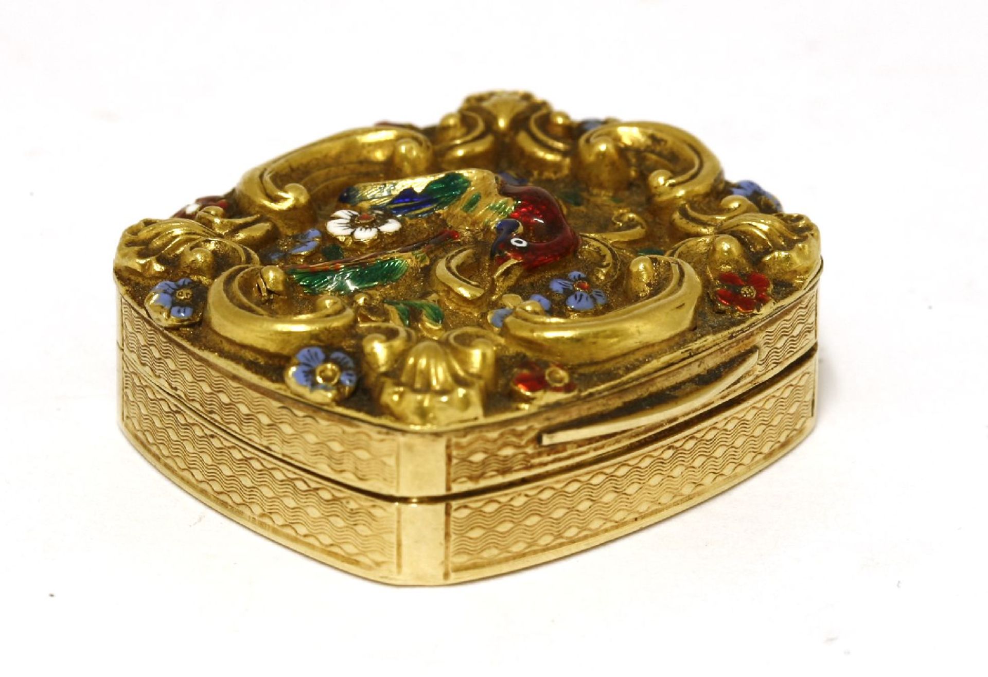A French gold vinaigrette,unmarked,the lid with repoussé decoration of a bird amongst flowers