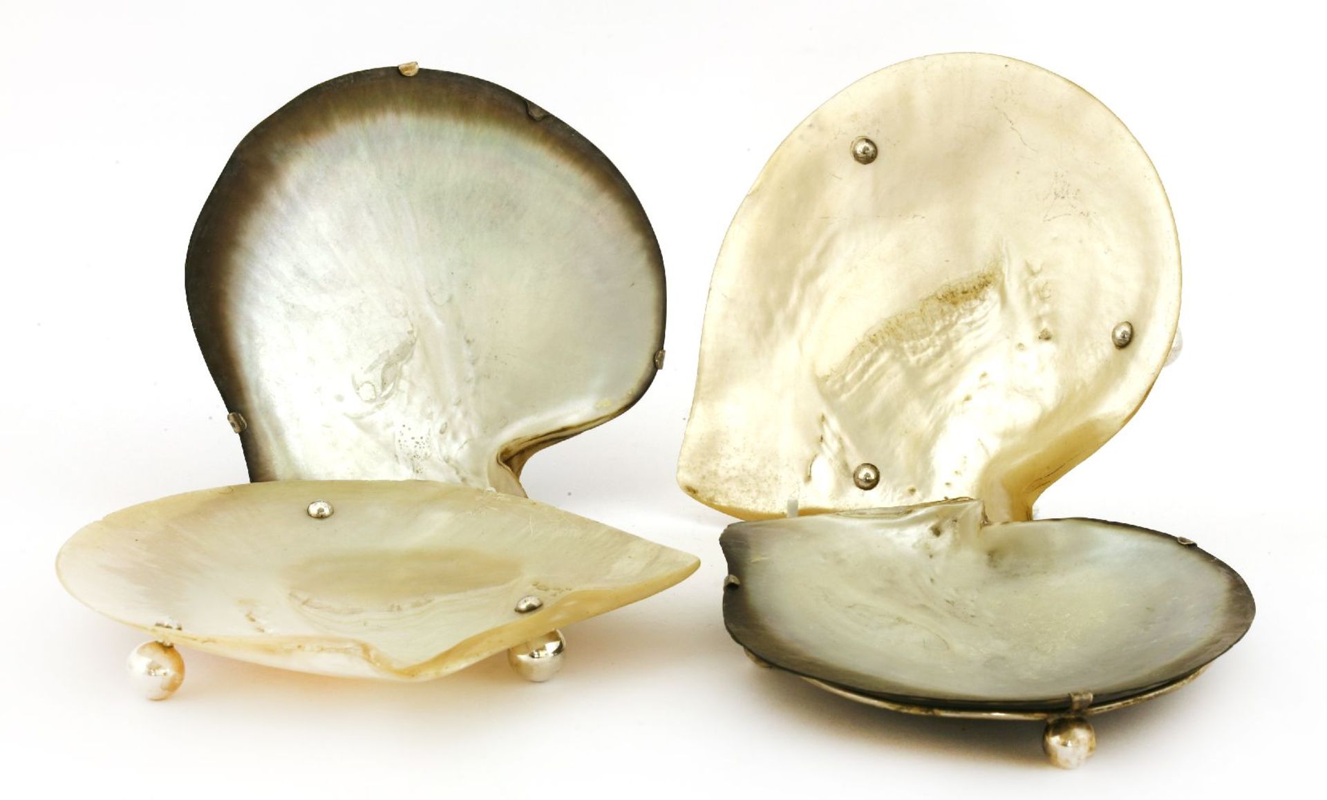 A pair of late Victorian abalone shell dishes,by Hukin & Heath, Birmingham, 1899,each with silver