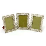 Three Continental silver photograph frames,each of upright rectangular form, with cast openwork