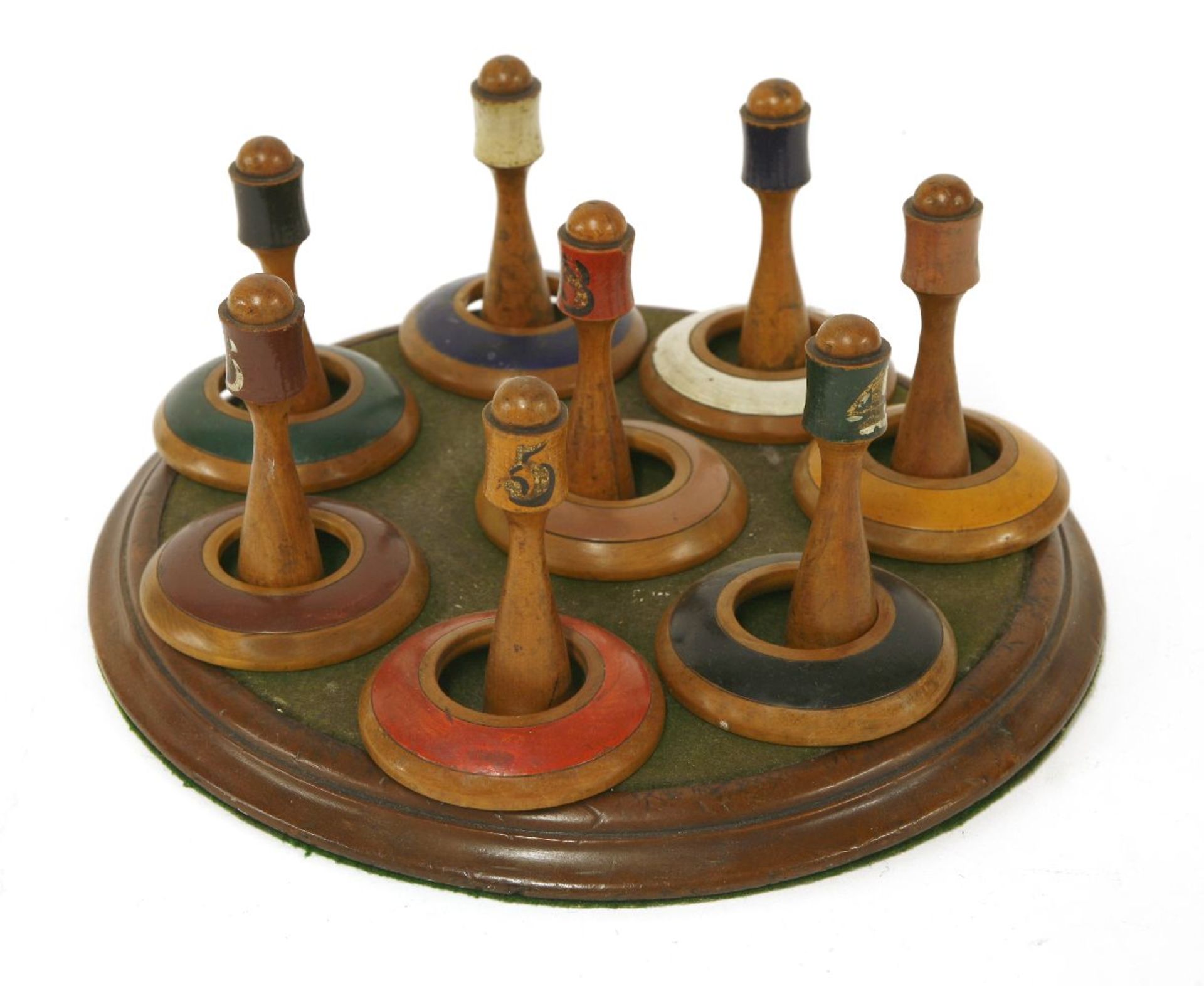 A Victorian set of wooden table quoits,with eight turned posts with painted numbers, on a circular