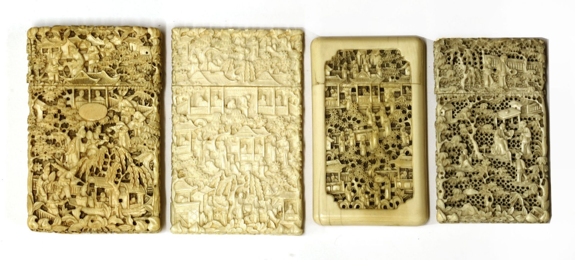 Four ivory cases, carved with figures in landscapes, pagodas, trees and foliage, one pierced, - Image 2 of 2