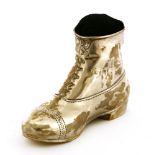 An Edwardian silver novelty pincushion,by Henry Matthews, Birmingham, 1906,in the form of a boot,7cm