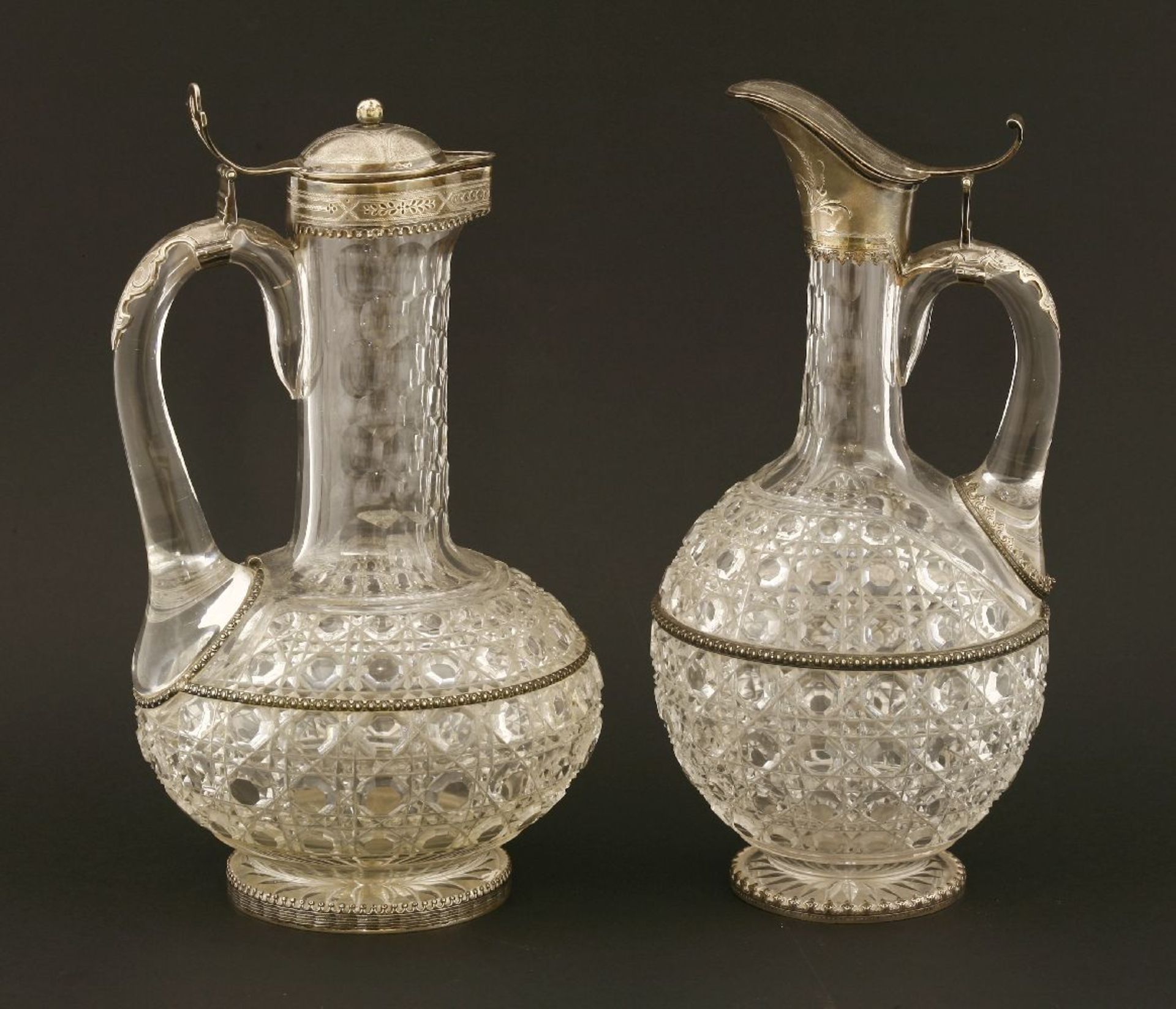A near pair of mid-19th century German jug glass and silver-mounted claret jugs, the cut bodies of - Image 2 of 3