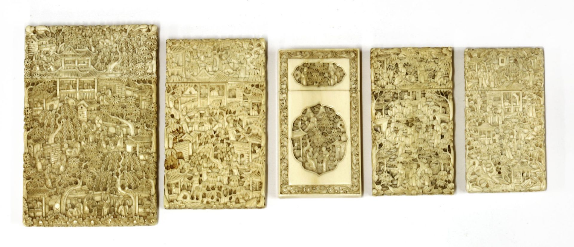 Five ivory cases,carved with figures in landscapes, pagodas, trees and flowers,largest 11.5 x 7.