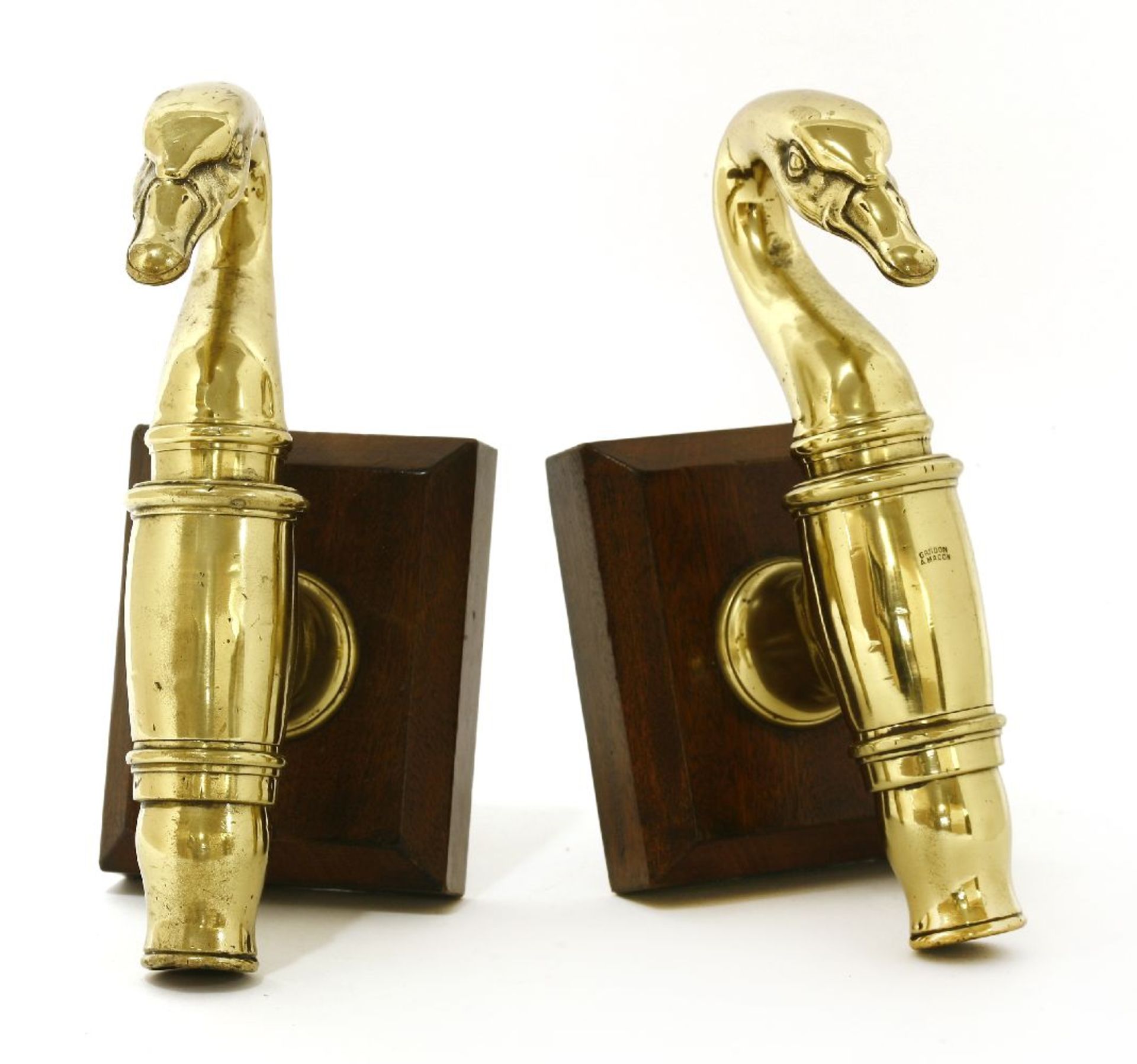 A pair of French polished brass taps,mid-19th century, each case in the form of a swan's head and