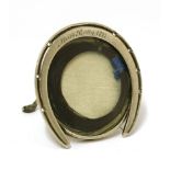 A small Victorian novelty silver photograph frame,apparently unmarked,in the form of a horseshoe,
