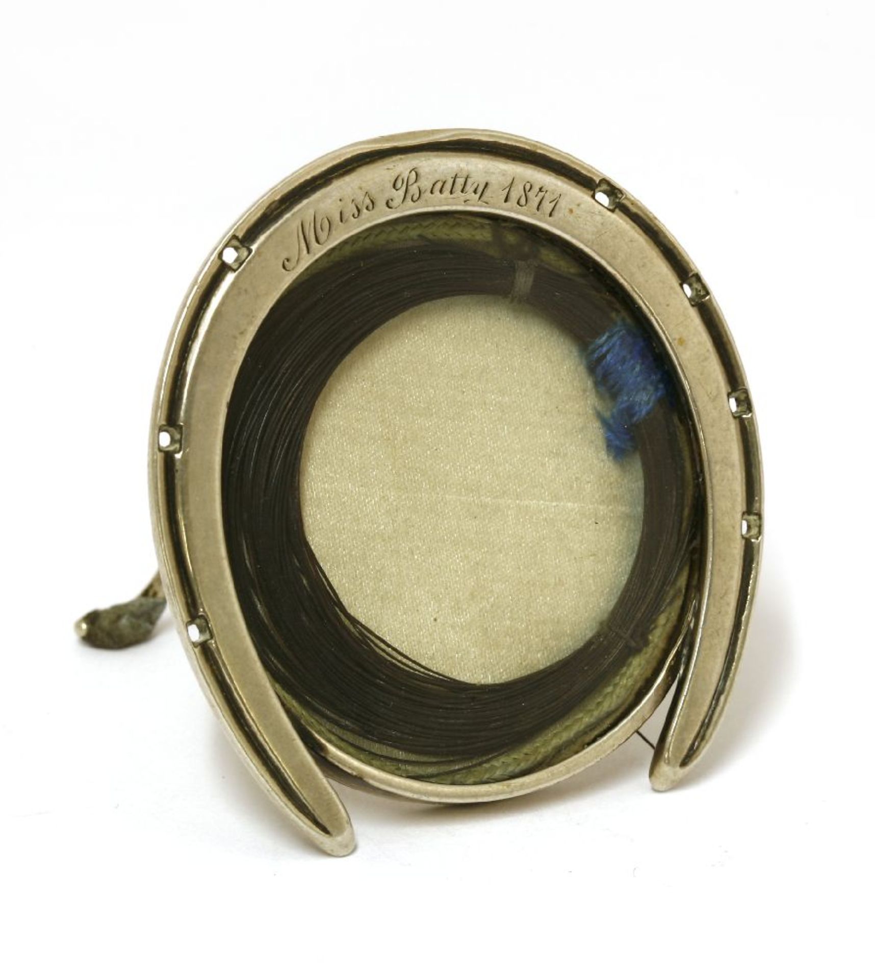 A small Victorian novelty silver photograph frame,apparently unmarked,in the form of a horseshoe,