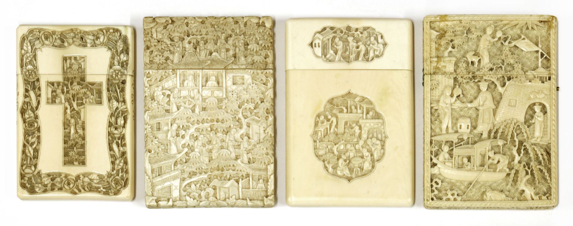 Four ivory cases,carved with figures in landscapes, pagodas, trees and foliage, one with crosses