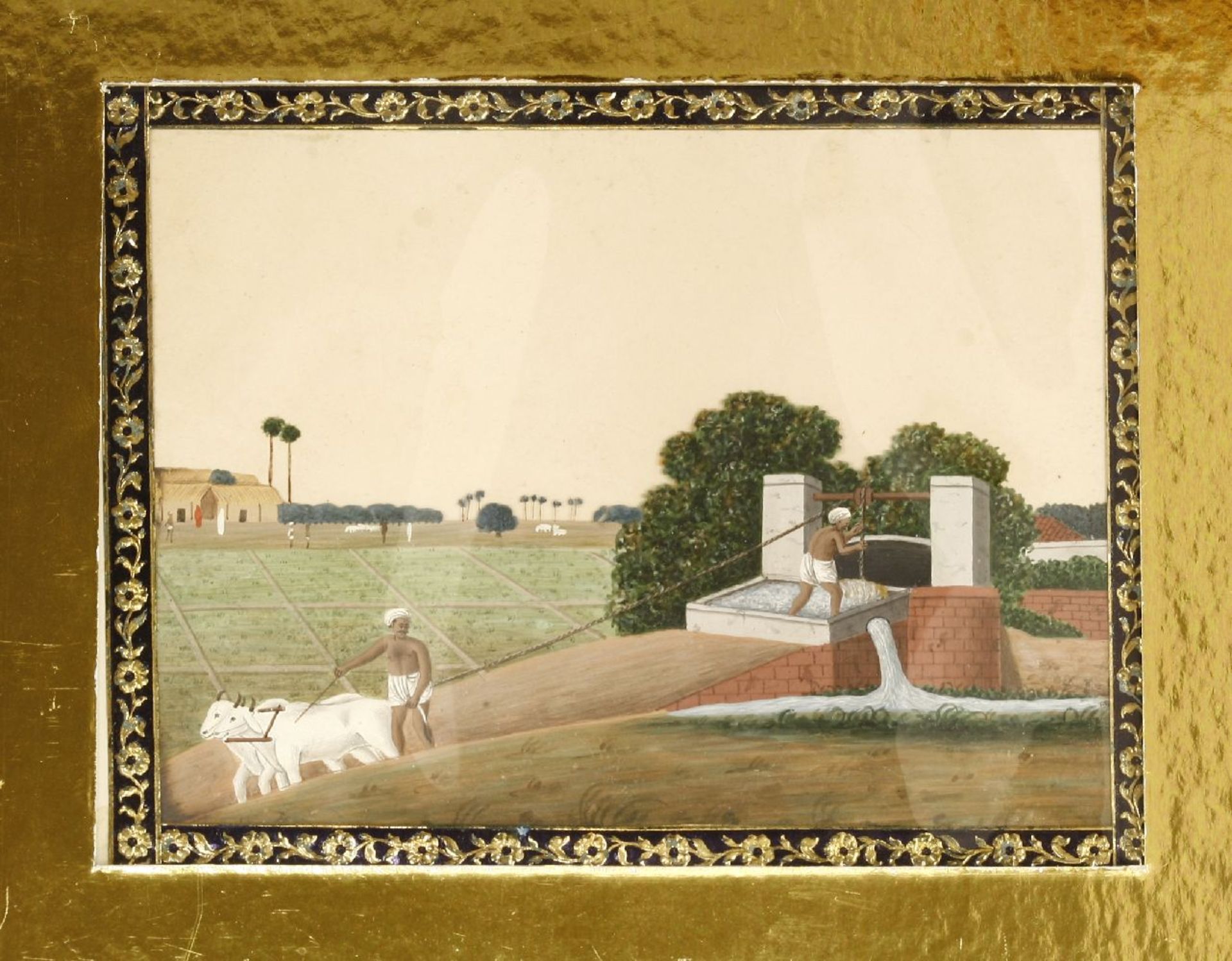 An Indian painting on mica,early 19th century, irrigating crops, figures and bullocks beside a dam,