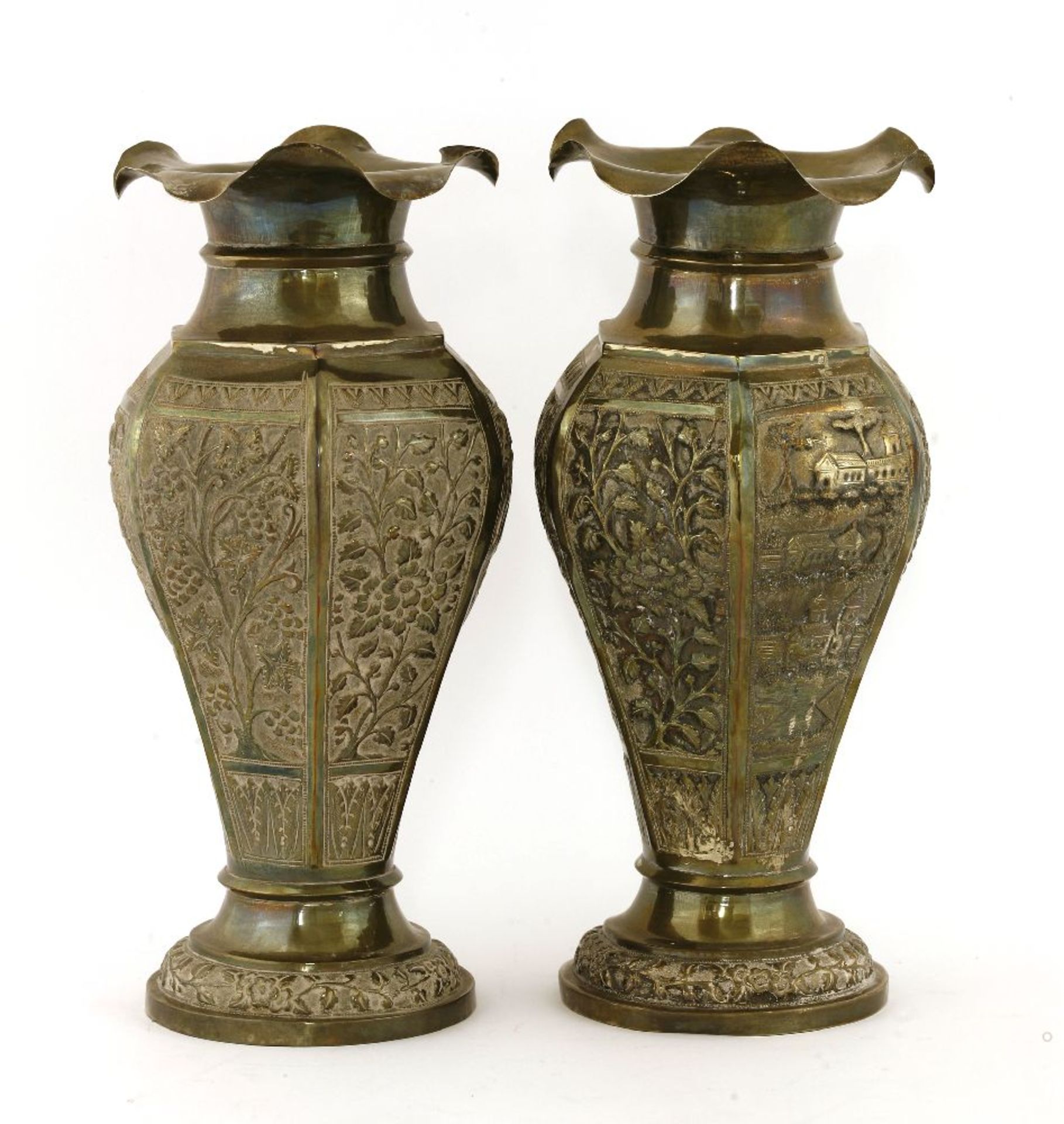 A pair of Indian silvered vases, unmarked,of hexagonal form, embossed with floral and landscape