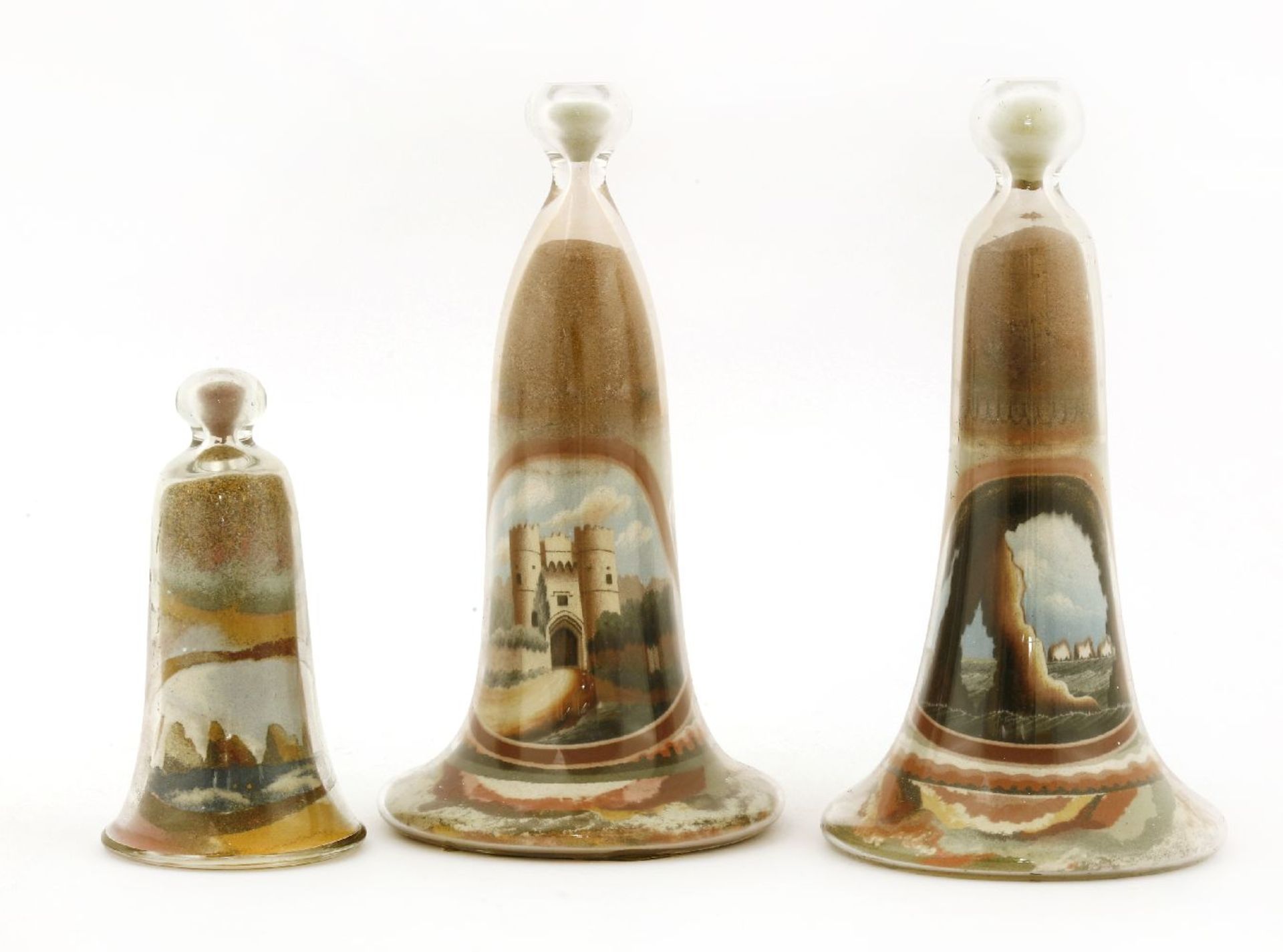 A pair of Alum Bay sand ornaments by W Carpenter,each in bell-shaped glass vessels, one with a