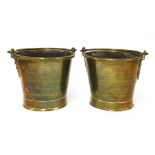 A pair of brass pail measures,with swing handles,20.5cm high (2)Provenance: The Priory, Walsham-le-