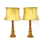 A pair of turned wooden, simulated marble table lamps,each with a cream silk shade,65cm high (2)