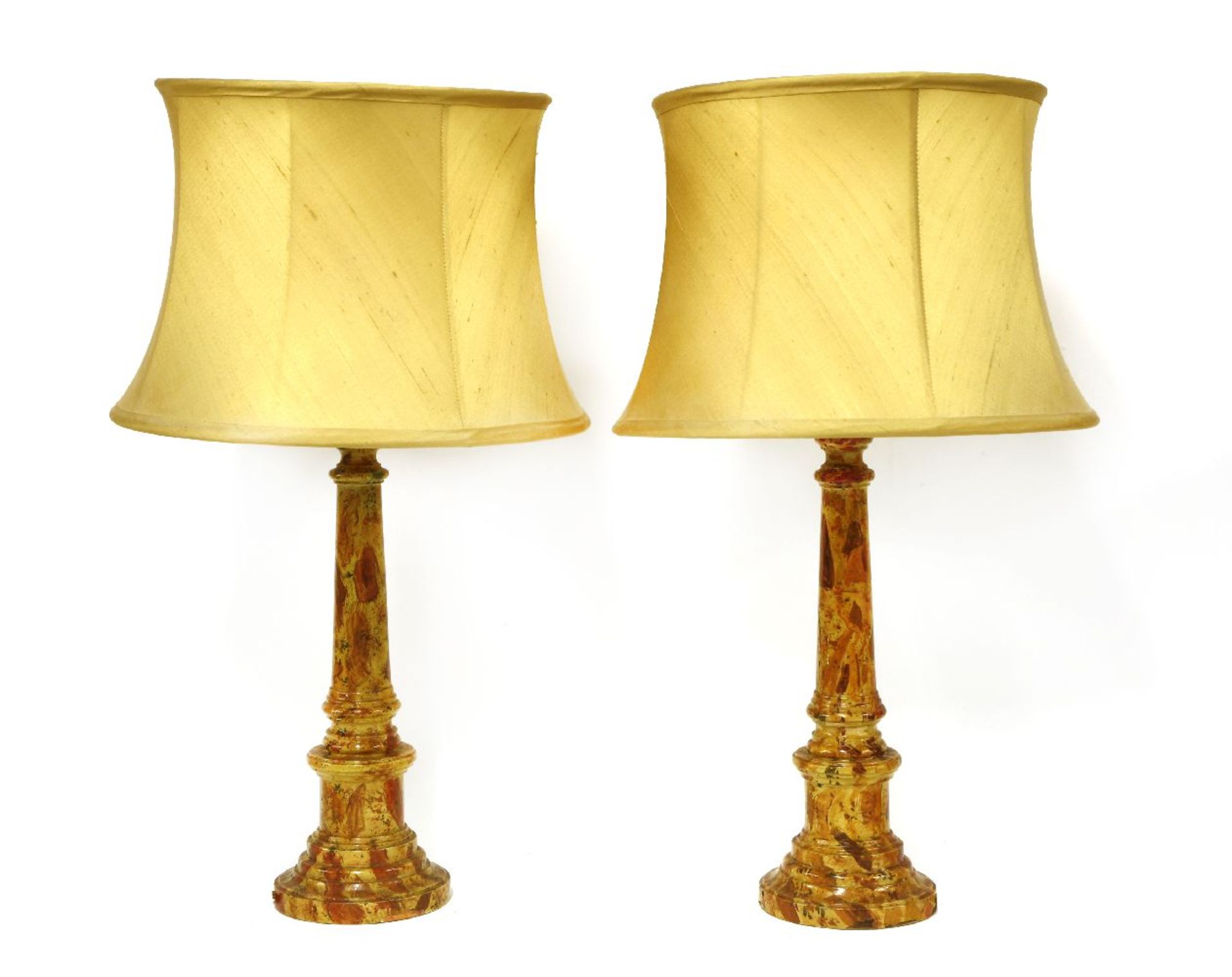 A pair of turned wooden, simulated marble table lamps,each with a cream silk shade,65cm high (2)