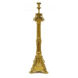 A large gilt metal candlestick, with pierced scrolling brackets and cluster column support on