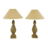 A pair of large turned wooden and grey painted table lamps,each of baluster form and carved with