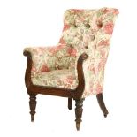 A William IV mahogany and button upholstered armchair,with scrolling reeded show frame and on turned