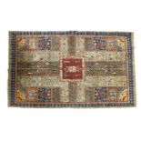 A hand-knotted Turkish rug,c.2000, the multicolour blue and red fields, with geometric reserves