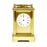 A miniature mignonette brass carriage clock,with a circular enamel dial,8cm highProvenance: The