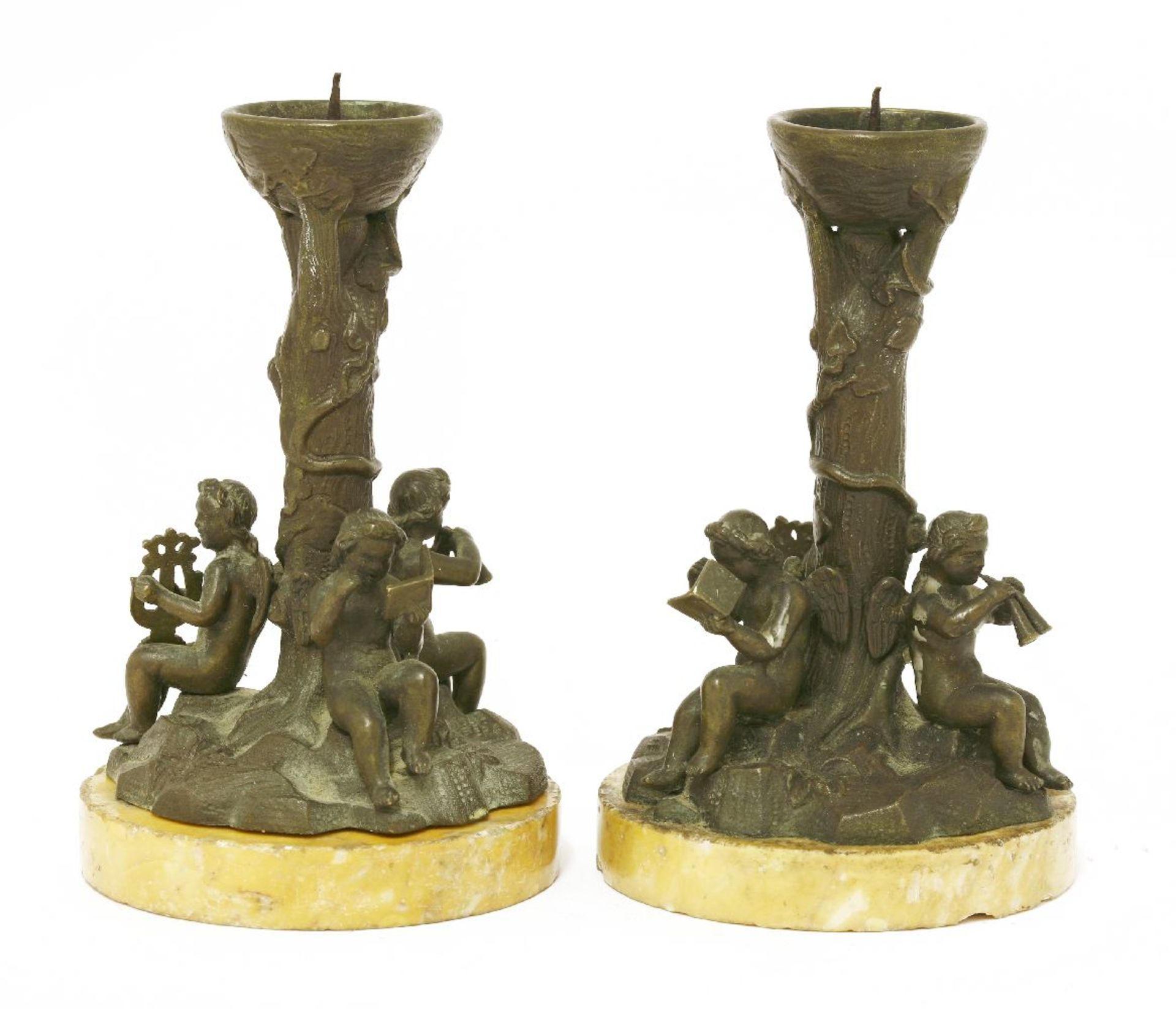 A pair of bronze candlesticks,late 19th century, each of pricket candlestick form, with a rusticated