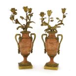 A pair of pink marble and ormolu candelabra, 19th century, each fitted with three floral branches
