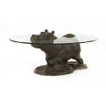 A modern 'Hippo' table by Mark Stoddart,the bronze partially 'submerged' under the glass oval top,