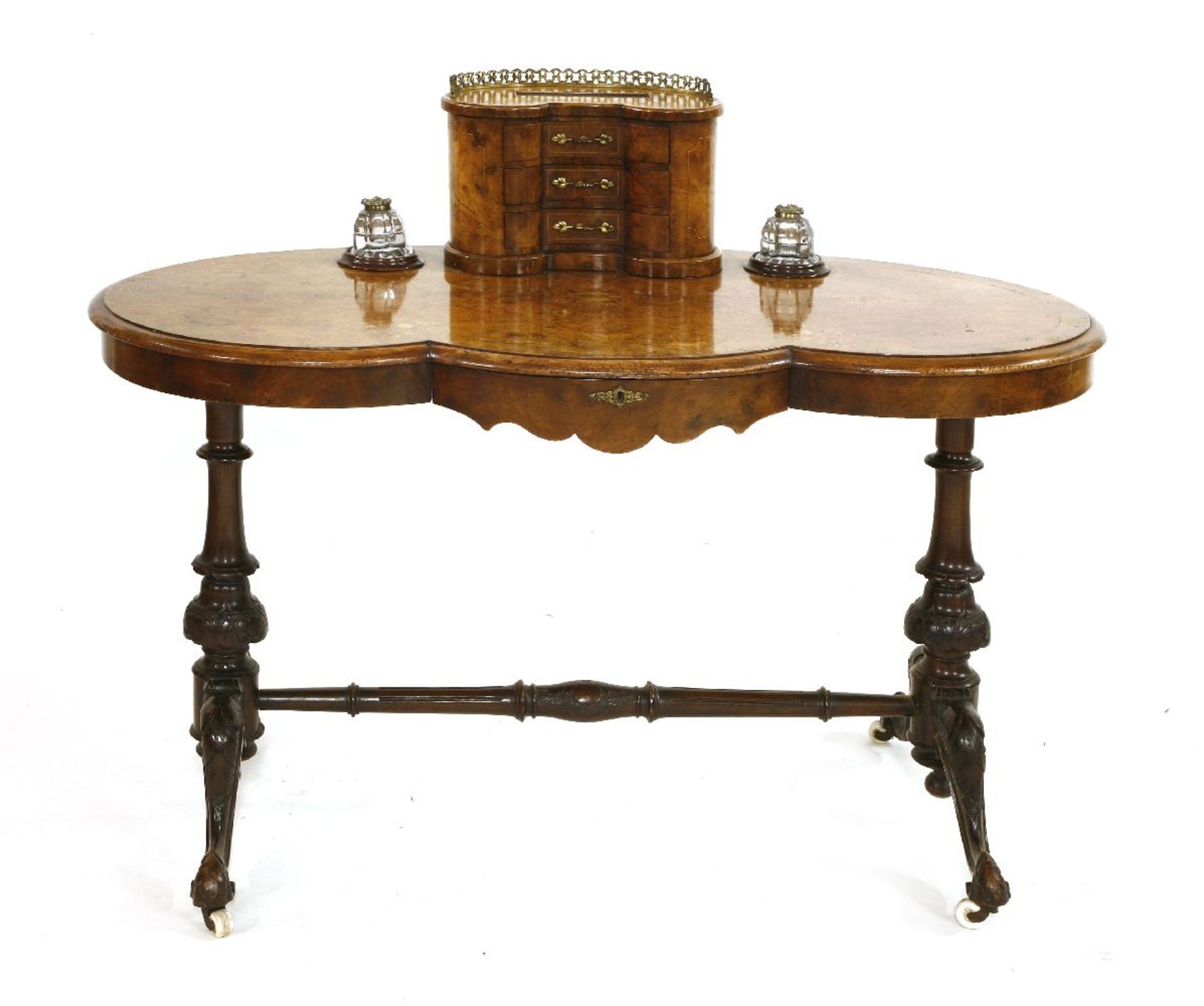A Victorian strung walnut bonheur-du-jour,of kidney shape, the raised back with three drawers over