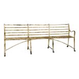 A Regency wrought iron garden seat, with slatted back and arched stretcher,240cm wide