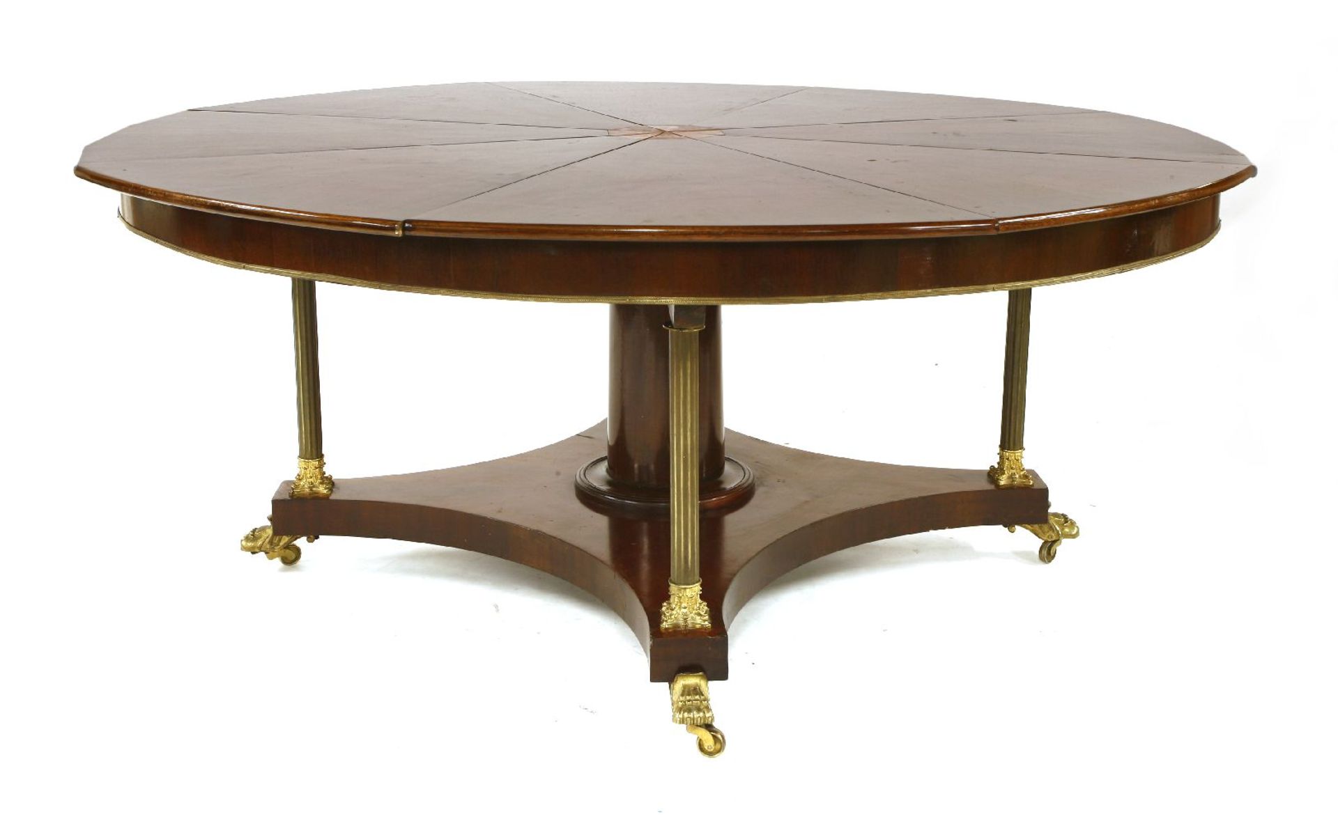 A large George III- style mahogany Jupe-style dining table,the circular eight divisional top on a