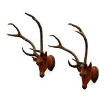 A pair of large carved wooden and painted Indian-style stag trophy heads,each approximately 100 x