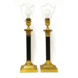 A pair of Corinthian column table lamps,with gilt capitals and on square stepped bases, stamped '
