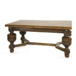 A 'Jacobethan' oak draw-leaf dining table,having a parquetry top on boldly turned supports and a